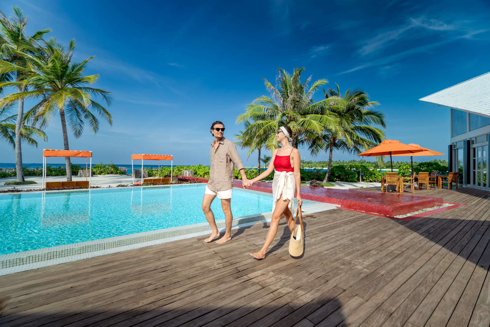 Couple walking along the adults-only pool